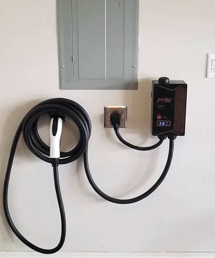 EV charging station wired beside a home electrical panel during a residential installation in Denver